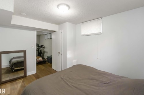 Bedroom featuring a textured ceiling and dark wood-type flooring - 6 Garraway Pl, St. Albert, AB - Indoor Photo Showing Bedroom