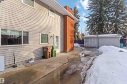 View of side of home featuring an outdoor structure and a patio area - 