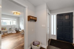 Foyer with dark wood-type flooring and baseboards - 