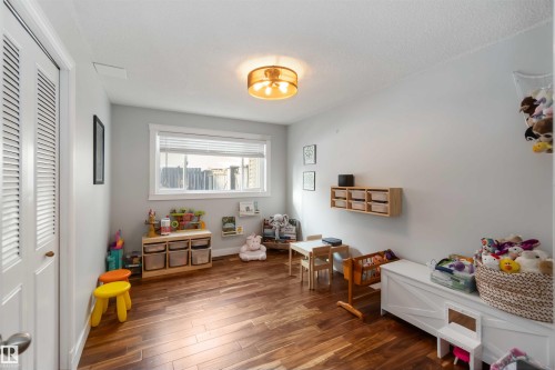Playroom featuring dark wood-type flooring and baseboards - 6 Garraway Pl, St. Albert, AB - Indoor