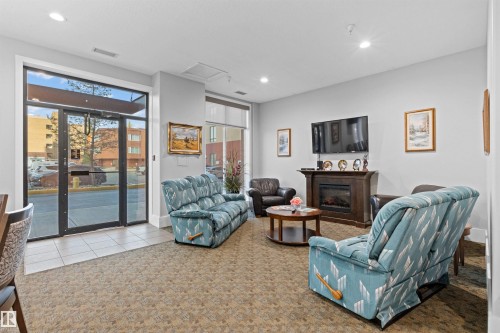 218 6608 28 Avenue, Edmonton, AB - Indoor Photo Showing Living Room With Fireplace
