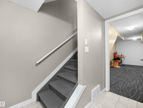 Staircase with a textured ceiling and carpet flooring - 791 Abbottsfield Road, Edmonton, AB - Indoor Photo Showing Other Room