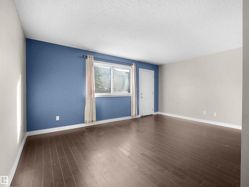 Spare room with a textured ceiling and dark wood-type flooring - 791 Abbottsfield Road, Edmonton, AB - Indoor Photo Showing Other Room