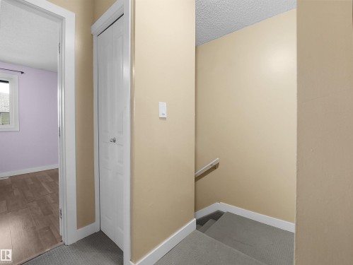 Hall with an upstairs landing and a textured ceiling - 791 Abbottsfield Road, Edmonton, AB - Indoor Photo Showing Other Room
