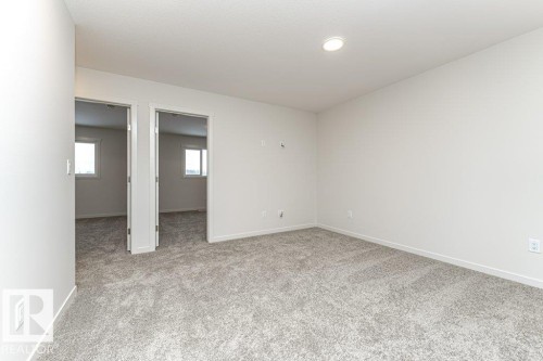 Unfurnished room featuring light carpet and baseboards - 3972 Wren Loop, Edmonton, AB - Indoor Photo Showing Other Room