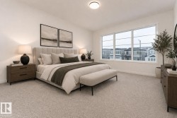 This bedroom features a large window, light-colored carpeting, and a modern ceiling light fixture - 