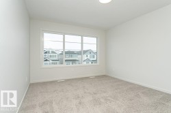 Carpeted empty room with baseboards - 