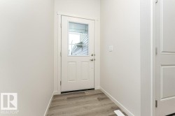Entryway with wood finished floors and baseboards - 