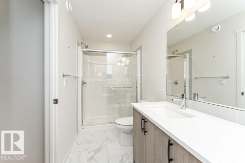 Bathroom featuring vanity, a stall shower, and light marble finish floors - 3972 Wren Loop, Edmonton, AB - Indoor Photo Showing Bathroom