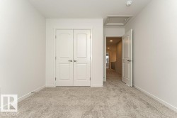 Unfurnished bedroom featuring light colored carpet and a closet - 