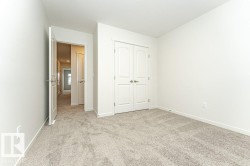 Unfurnished bedroom featuring light carpet and a closet - 