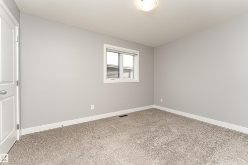 Carpeted empty room featuring baseboards - 3611 Keswick Boulevard, Edmonton, AB - Indoor Photo Showing Other Room