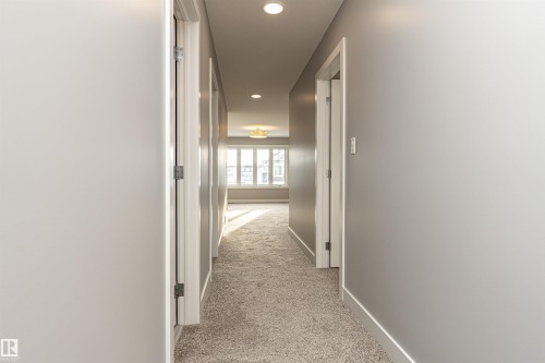 Hallway featuring light colored carpet and recessed lighting - 3611 Keswick Boulevard, Edmonton, AB - Indoor Photo Showing Other Room