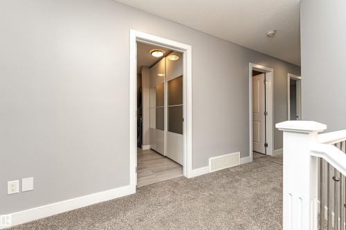 Corridor featuring light colored carpet - 3611 Keswick Boulevard, Edmonton, AB - Indoor Photo Showing Other Room