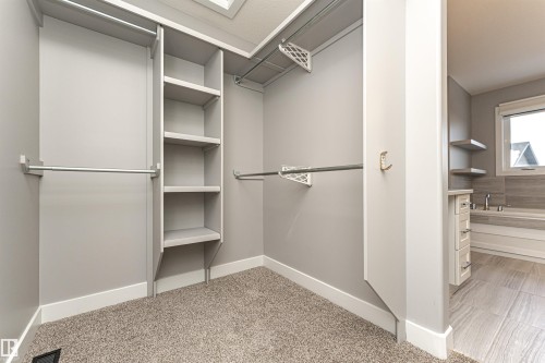 Walk in closet with light colored carpet - 3611 Keswick Boulevard, Edmonton, AB - Indoor With Storage