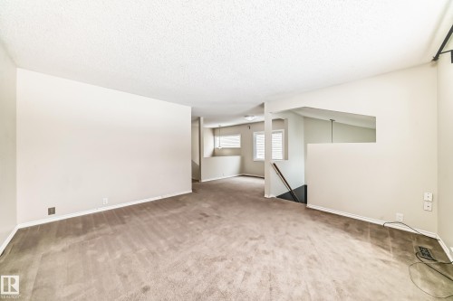 Empty room featuring light carpet and baseboards - 5308 20 Avenue, Edmonton, AB - Indoor Photo Showing Other Room