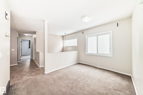 Unfurnished room featuring carpet flooring and baseboards - 5308 20 Avenue, Edmonton, AB - Indoor Photo Showing Other Room