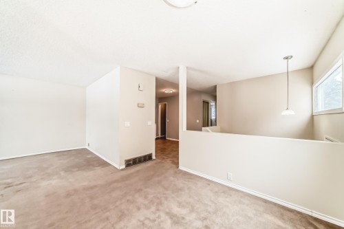 Unfurnished room with carpet flooring and baseboards - 5308 20 Avenue, Edmonton, AB - Indoor Photo Showing Other Room