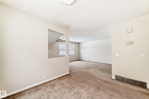 Spare room featuring carpet flooring and a textured ceiling - 5308 20 Avenue, Edmonton, AB - Indoor Photo Showing Other Room