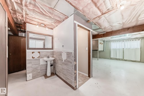 Bathroom featuring finished concrete flooring and a wainscoted wall - 5308 20 Avenue, Edmonton, AB - Indoor Photo Showing Basement