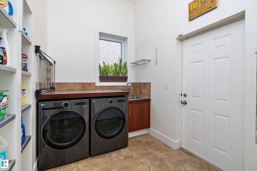 Laundry room with washing machine and clothes dryer and a sink - 169 Callaghan Drive, Edmonton, AB - Indoor Photo Showing Laundry Room