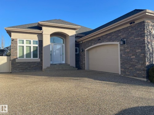 View of front facade with stone siding, stucco siding, and driveway - 169 Callaghan Drive, Edmonton, AB - Outdoor