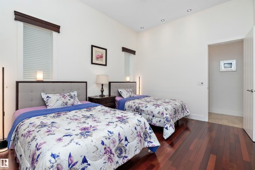 Bedroom with dark wood-type flooring and baseboards - 169 Callaghan Drive, Edmonton, AB - Indoor Photo Showing Bedroom