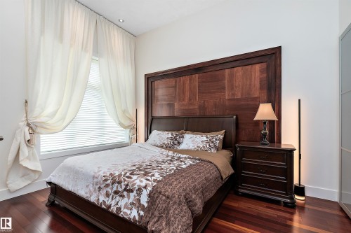 Bedroom with dark wood-type flooring and baseboards - 169 Callaghan Drive, Edmonton, AB - Indoor Photo Showing Bedroom