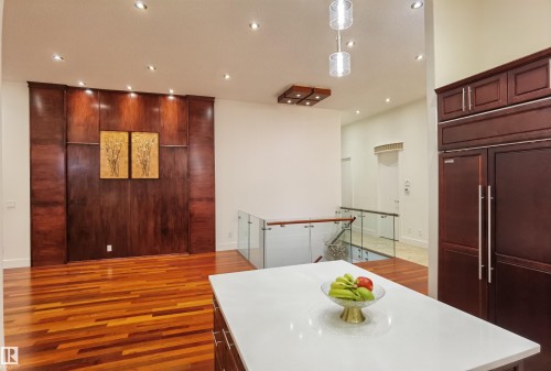 Kitchen featuring light wood finished floors, paneled built in refrigerator, a kitchen island, and pendant lighting - 169 Callaghan Drive, Edmonton, AB - Indoor