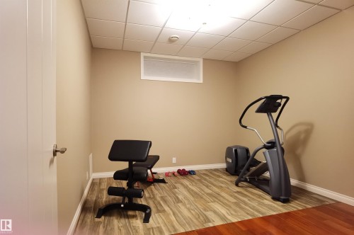 Exercise area featuring a paneled ceiling and wood finished floors - 169 Callaghan Drive, Edmonton, AB - Indoor Photo Showing Gym Room