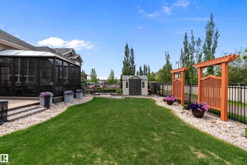 Fenced backyard with a storage shed, a patio area, and a sunroom - 169 Callaghan Drive, Edmonton, AB - Outdoor