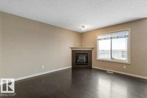 130 Keystone Crescent, Leduc, AB - Indoor Photo Showing Living Room With Fireplace