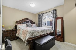 Bedroom with light carpet and a textured ceiling - 