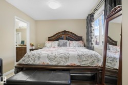 Bedroom featuring a textured ceiling and ensuite bathroom - 