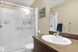 Full bath with a stall shower, vanity, and a textured ceiling - 