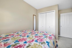 Bedroom featuring carpet, a textured ceiling, and a closet - 