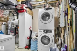 Laundry area featuring estacked washer and dryer and electric water heater - 