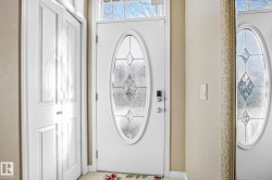 Foyer with healthy amount of natural light and tile patterned flooring - 
