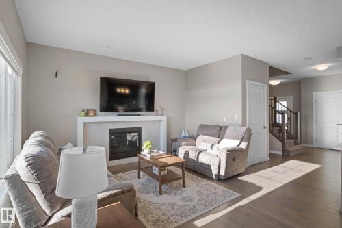 Living room featuring wood finished floors and a fireplace - 3904 5 Street, Edmonton, AB - Indoor Photo Showing Living Room With Fireplace