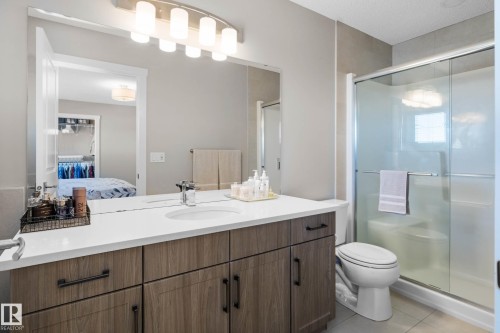 Bathroom with vanity, a stall shower, and light tile patterned flooring - 3904 5 Street, Edmonton, AB - Indoor Photo Showing Bathroom
