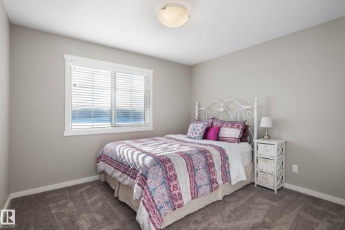 Carpeted bedroom featuring baseboards - 3904 5 Street, Edmonton, AB - Indoor Photo Showing Bedroom