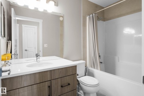 Bathroom with vanity and shower / bath combination with curtain - 3904 5 Street, Edmonton, AB - Indoor Photo Showing Bathroom