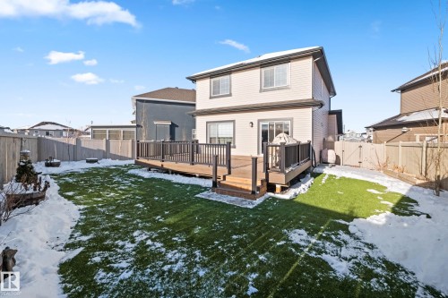 Snow covered house with a gate, a fenced backyard, and a deck - 3904 5 Street, Edmonton, AB - Outdoor With Deck Patio Veranda