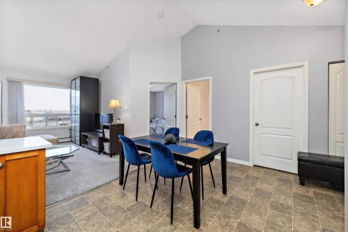 Dining area with stone finish flooring and vaulted ceiling - 2407 320 Clareview Station Drive, Edmonton, AB - Indoor
