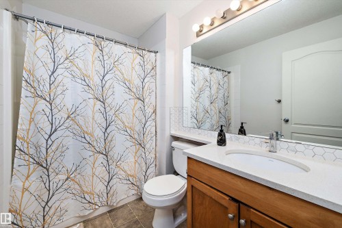 Bathroom featuring vanity and dark tile patterned floors - 2407 320 Clareview Station Drive, Edmonton, AB - Indoor Photo Showing Bathroom