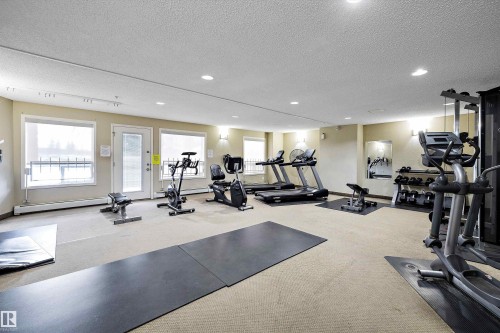 Gym featuring a textured ceiling, recessed lighting, and a baseboard radiator - 2407 320 Clareview Station Drive, Edmonton, AB - Indoor Photo Showing Gym Room