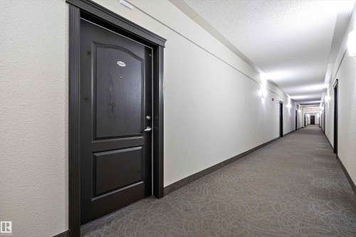 Hall with carpet and a textured ceiling - 2407 320 Clareview Station Drive, Edmonton, AB - Indoor Photo Showing Other Room