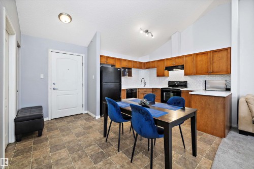 Dining room featuring vaulted ceiling and stone finish floors - 2407 320 Clareview Station Drive, Edmonton, AB - Indoor Photo Showing Kitchen