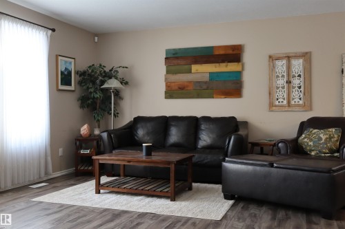 Living area featuring wood finished floors and baseboards - 5220 - 56 Street, Barrhead, AB - Indoor Photo Showing Living Room