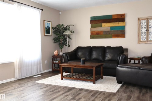 Living room featuring wood finished floors and baseboards - 5220 - 56 Street, Barrhead, AB - Indoor Photo Showing Living Room